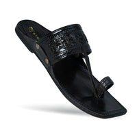Black sandal with decorative straps on a white background